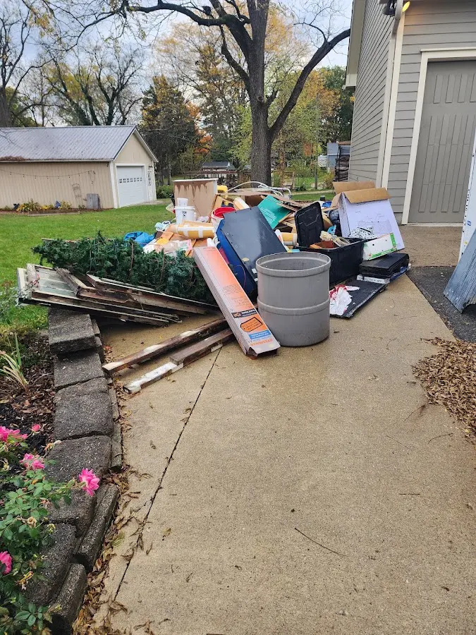 Dumpster being loaded with debris for Estate Cleanout Dumpster Rental in Cranbury